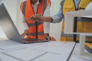 Construction and structure concept of Engineer or architect meeting for project working with partner and engineering tools on model building and blueprint in working site, contract for both companies.